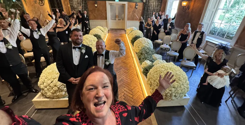 Sarah celebrating with wedding guests before a ceremony