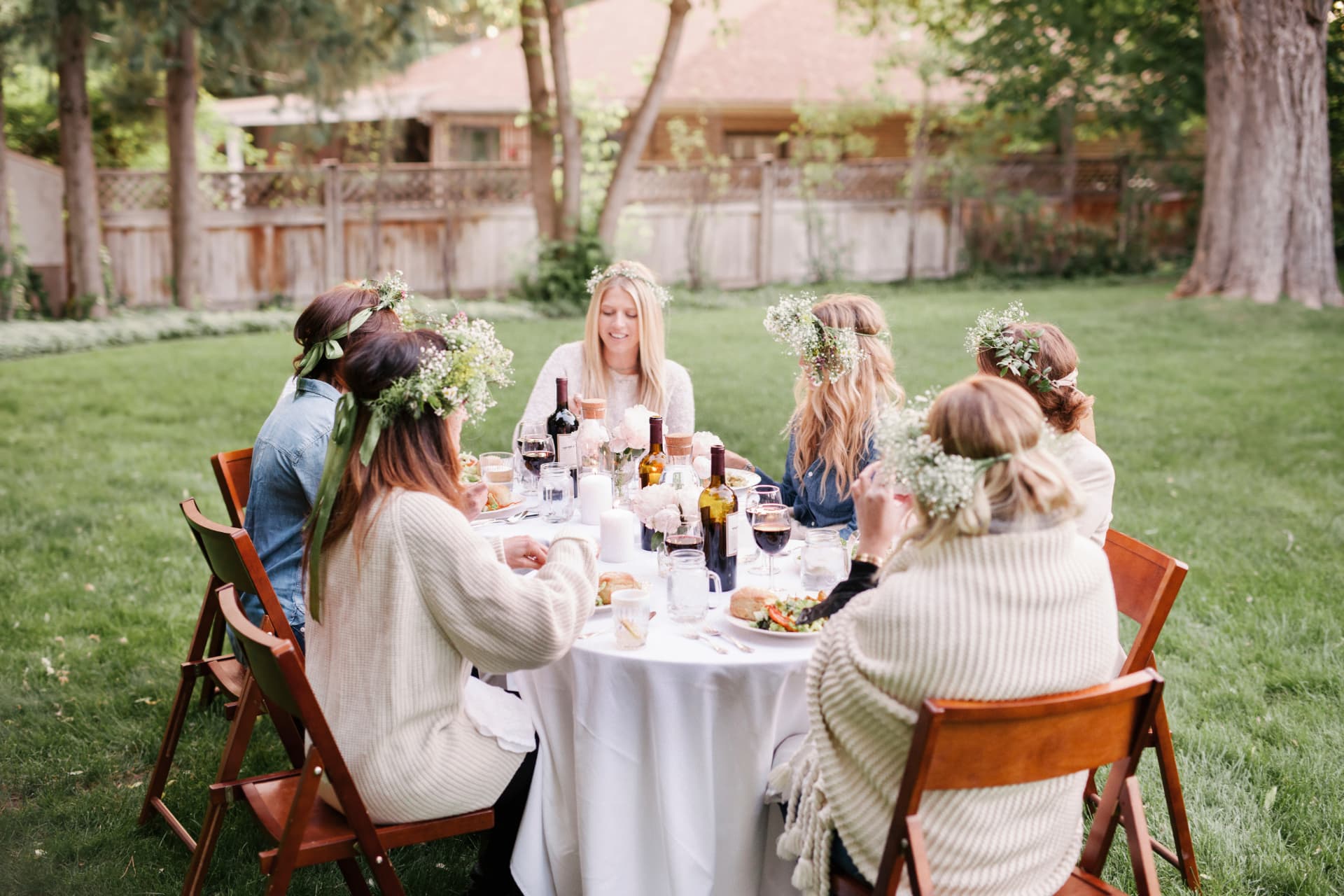 Friends gathered around a garden table sharing food and stories